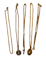 Photo of five necklaces laid out showing pendants and chain styles