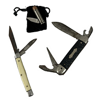 Three pocketknives laid out including a black handle Forest-Master knife with multiple blades and tools, a pearl colored handle Sabra Japan knife with two blades, and a small converted 44 Mag bullet folding knife in a black pouch.
