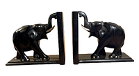 Front side view of the pair of wooden elephant bookends, showing the right-facing and left-facing elephants with raised trunks on rectangular bases.