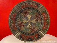 Full top view of the circular brass cloisonné bowl showing outer rim with brass segments and colorful enamel patterns.