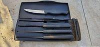 Complete Pampered Chef cutter set with knives in black case.