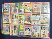 Top view photo showing an assortment of vintage baseball cards including 1974 Highlights, rookie relief pitchers from 1975, strikeout leaders and more.