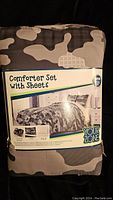 Photo of the packaged comforter set showing label with product information and camouflage print