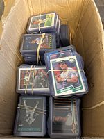 Top view of box packed with stacked baseball cards, many sleeved and rubber-banded in groups.