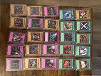A photo of YuGiOh! trading cards laid out flat on a surface, showing a row of monster, spell, and trap cards.