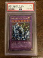 Front of YuGiOh! Dragon Master Knight 1st edition card in PSA slab with grade label and card details