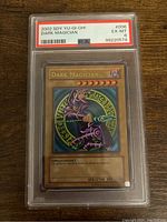 Front of YuGiOh! Dark Magician trading card in PSA graded protective case showing card name, grade (6 EX-MT), and serial number.