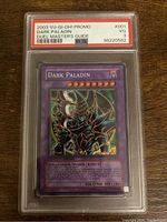 Front of 2003 YuGiOh! Dark Paladin promo card graded PSA 3 in hard plastic case showing holographic card artwork and text