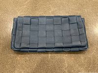 Top view of the blue woven leather clutch bag