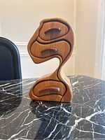 Front view of handcrafted oak bandsaw box with three drawers and flowing organic shape