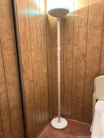 Full view of the Brightec SkyLite LED torchiere floor lamp showing the full white pole and round base.