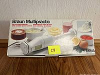 Photo of the Braun Multipractic Deluxe hand blender in its original box showing product image and brand name.