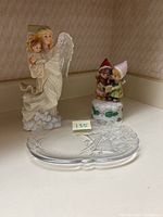 Wide view of the angel figurine, children figurine, and glass dish together showing the full lot.