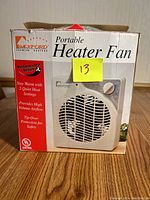 Photo of the front side of the box showing the heater fan image and key features like 2 quiet heat settings, 1500 watts, tip-over protection.