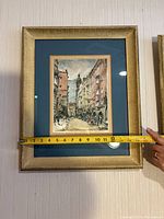 Frontal photo of framed watercolor painting showing width measurement tape crossing horizontally at 12 inches.