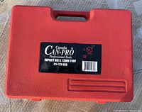 Closed red carrying case with Can-Pro label detailing impact drill 13mm 110V model ZI-13T-650.