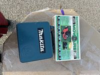 Closed Makita drill case with Mow Aire aerator box on top