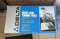 Box labeled Delta Model 46-730 Wood Lathe Turning Tools illustrating the tool set and its features.