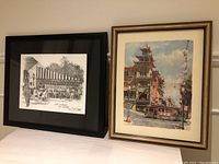 Two framed prints by Don Davey shown side by side on table. Left is black-and-white New Orleans scene in black frame, right is color San Francisco Chinatown scene in gold frame.