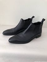 Side view of pair of black leather Chelsea boots by Hugo Boss Lisbon model, men's size 7