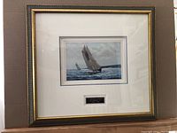 Front view of the framed print showing the art and plaque below the image.