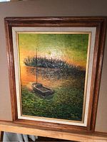 Framed vintage oil painting of a boat on water with green and orange sunset tones, signed by Paul Gregoire 1979.