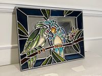 Front angled view of the resin art piece showing two parrots on a branch, highlighting colors and mirrored background.