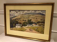 Framed watercolour landscape painting signed W.S. Turner, showing rural houses, hills, horse and cart, and cloudy sky.