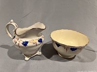 Creamer and sugar bowl side by side, showing overall size and decoration