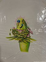 Front view of colorful budgerigar bird illustration on paper with some reflections from protective wrapping.