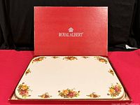 Two Royal Albert Old Country Roses corked placemats inside the original red box, showing floral decorative edges.