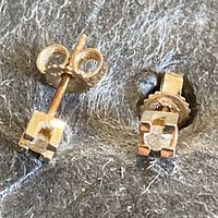 One stud face view showing round diamond in square four-prong setting and butterfly back