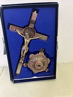 Crucifix and base in original packaging showing fits and details