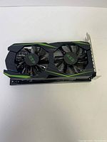 Front view showing the black and green dual-fan cooling system of the graphics card.