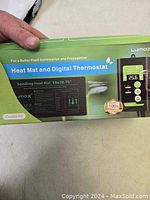 Photo of product box front with Lumax branding and combo kit title showing heat mat and digital thermostat illustrations.