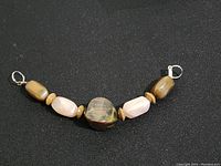 Photo of the Tibetan style necklace showing central smoky bead, pink and brown beads, and metal clasp ends