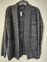 Front view of the grey women's knit sweater jacket on hanger.