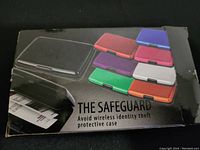 Photo of the opened and closed protective case packaging showing multiple color options and highlighting wireless identity theft protection.