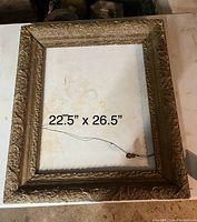 Ornate wooden frame with floral carvings, 22.5 x 26.5 inches, hanging wire attached