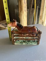 Side view of ceramic horse vase with measuring tape showing height about 4 inches