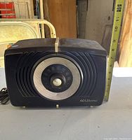 Front view of RCA Victor vintage tabletop radio with measuring tape displaying height approx. 6 inches