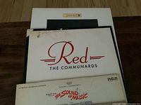 Photo showing three album covers stacked: Red by The Communards, The Sound of Music soundtrack, and another album at bottom mostly obscured