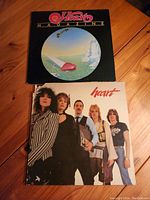 Top view of Heart Magazine album cover with surreal artwork of heart and landscape.