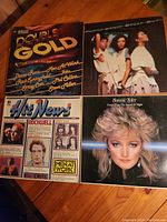 Four vinyl record album covers arranged on a surface, showing titles and artist names