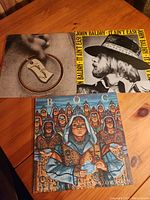 Three vinyl albums placed on a wooden table showing front covers: two John Baldry albums and one BoCA album.