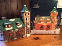 Porcelain lighted holiday fire station building with green snow-dusted roofs, showing front and side details and original box