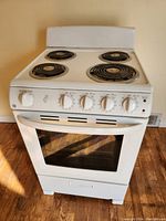 Front view showing four coil burners and control panel