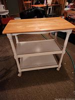 Overall view of the Ikea rolling shelf cart showing wooden top and two lower shelves.