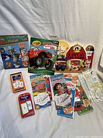 Photo of various children's educational materials including coloring books, activity pads, flashcards, and themed children’s storybooks.