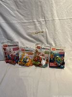 Four MEGA Construx Inventions building sets in sealed original packaging displayed against white background.